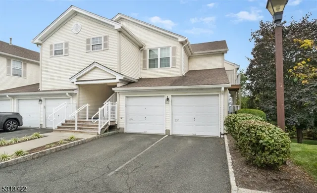 a view of a white house with a yard and plants