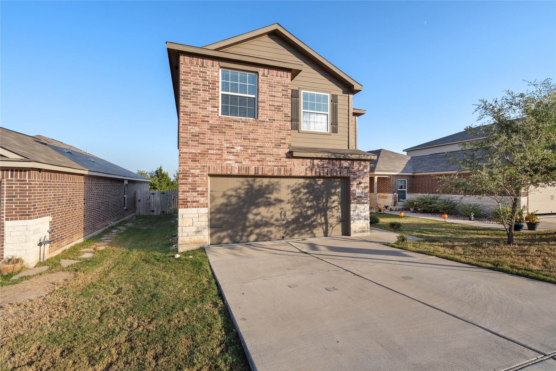 20205 Grover Cleveland Way Manor, TX 78653 - Photo 2 of 26 a front view of a house with a yard