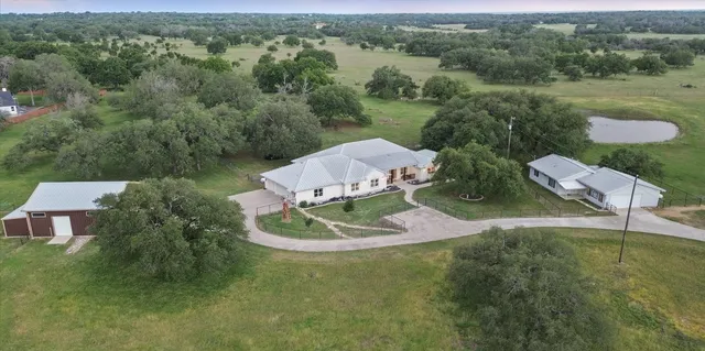 an aerial view of a house with outdoor space