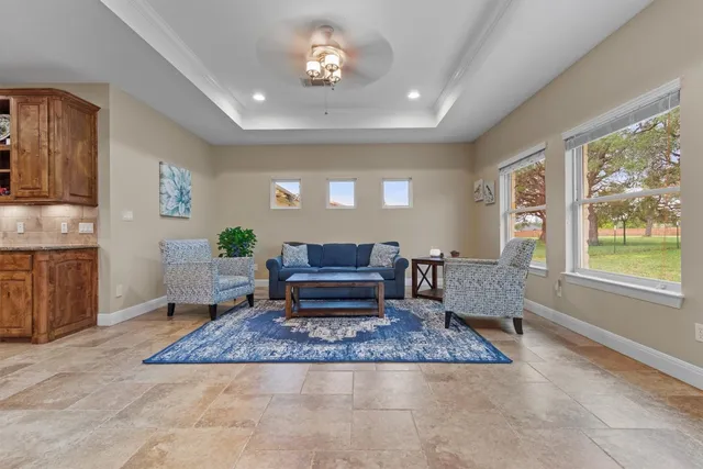a dining room with furniture a large window and kitchen view