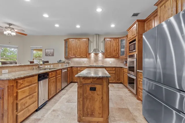 a kitchen with stove cabinets and refrigerator