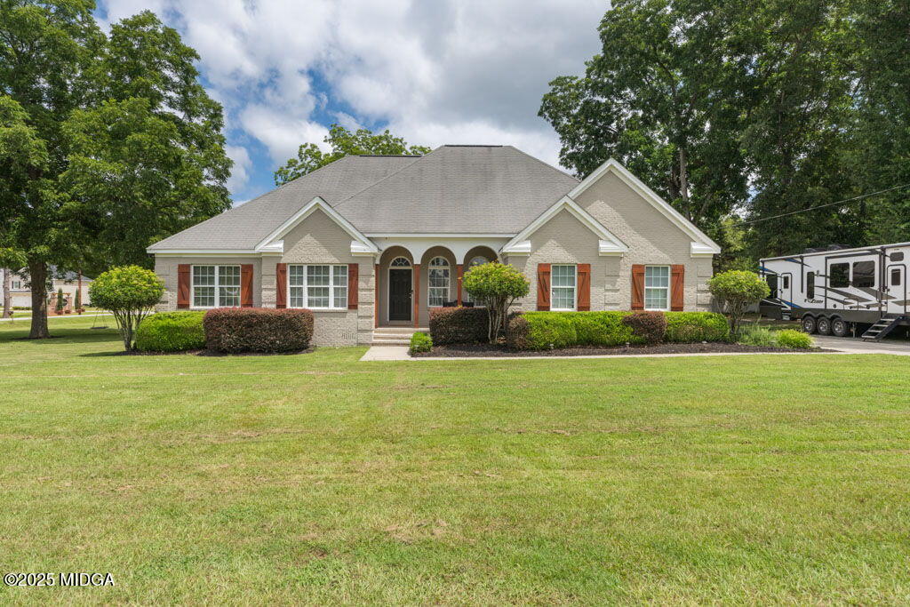 a front view of a house with a garden