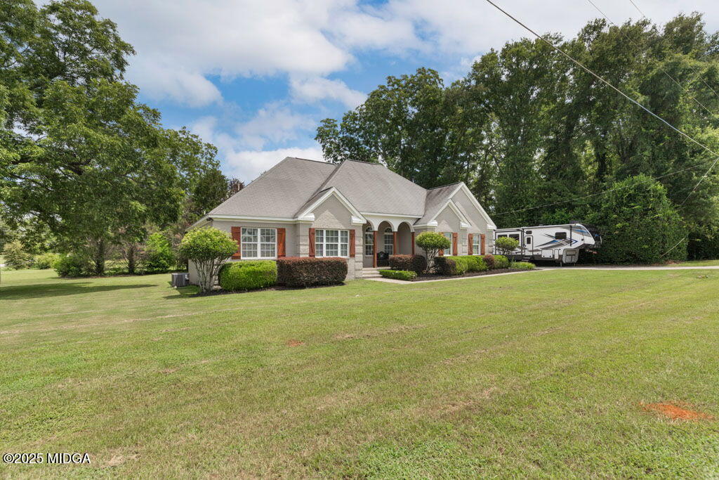 104 Browning Pointe Road Macon, GA 31216 - Photo 18 of 38 a view of a house next to a big yard and large trees