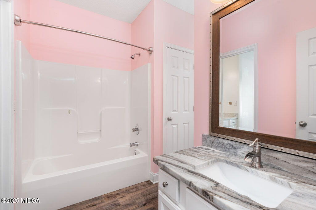 104 Browning Pointe Road Macon, GA 31216 - Photo 29 of 38 a bathroom with a granite countertop sink mirror and a bathtub