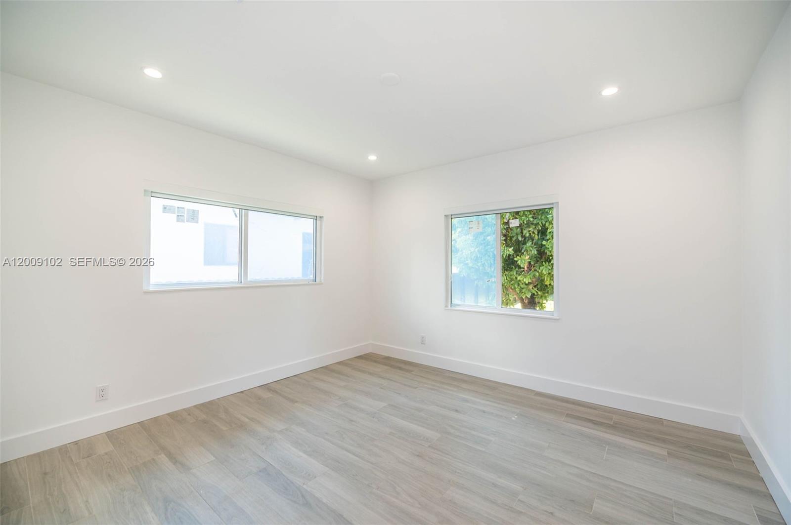 330 Southwest 27th Road Miami, FL 33129 - Photo 22 of 62 an empty room with wooden floor and windows