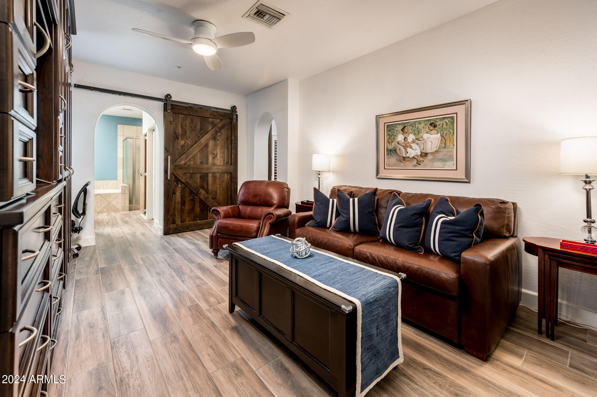 3935 East Rough Rider Road, Unit 1007 Phoenix, AZ 85050 - Photo 21 of 39 a living room with furniture and a wooden floor