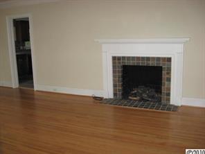 3711 Park Road Charlotte, NC 28209 - Photo 4 of 16 a view of an empty room with wooden floor and a fireplace