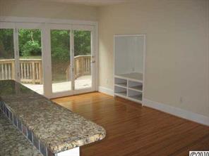 3711 Park Road Charlotte, NC 28209 - Photo 7 of 16 an empty room with wooden floor and windows