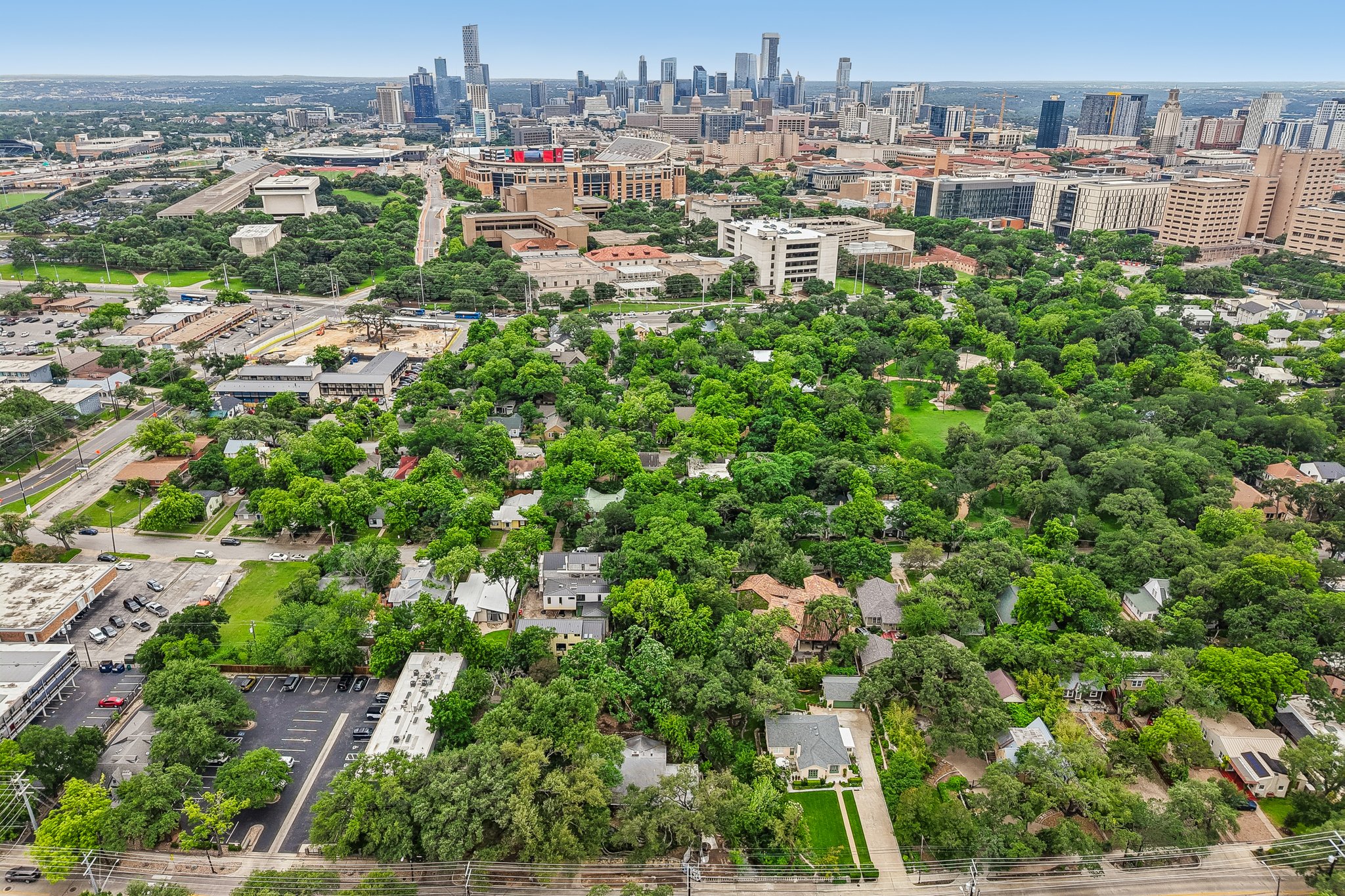 801 East 32nd Street Austin, TX 78705 - Photo 10 of 13 An aerial perspective reveals a tree-filled neighborhood bordering the dynamic city skyline.