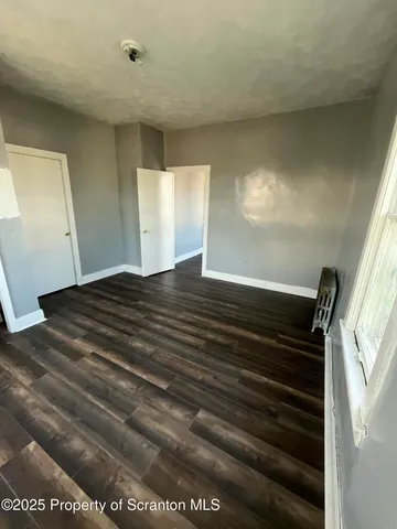 a view of wooden floor and windows in an empty room