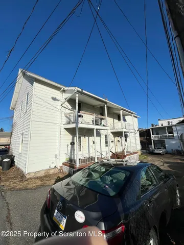 a view of a patio with table and chairs under an umbrella