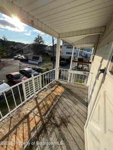 a view of a patio with wooden floor