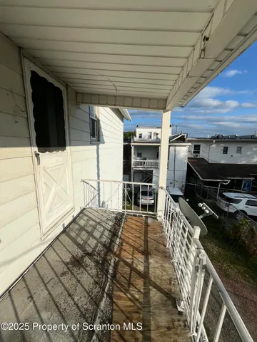 a living room with a washing machine and a flat screen tv