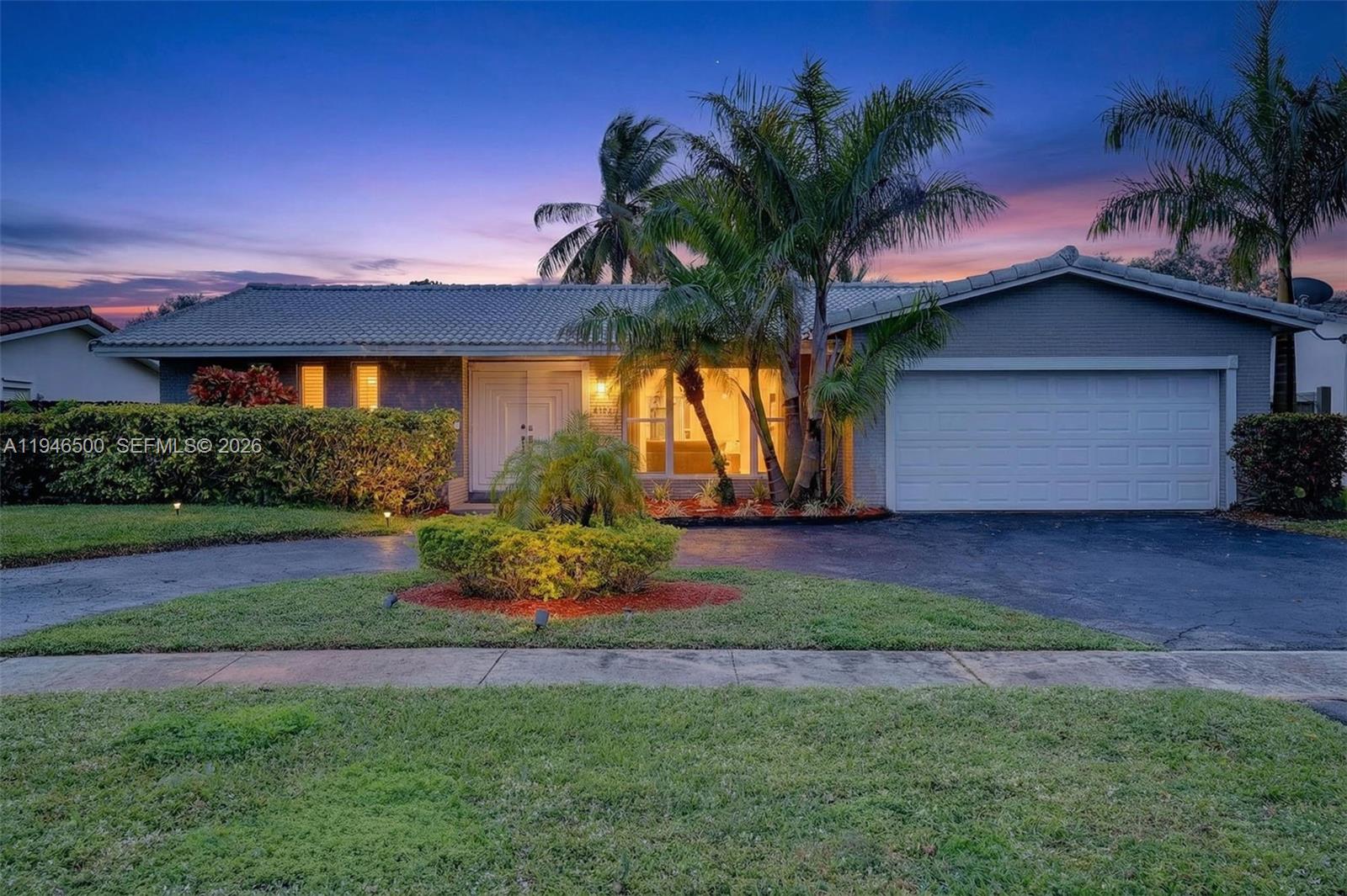 a front view of house with yard and outdoor seating