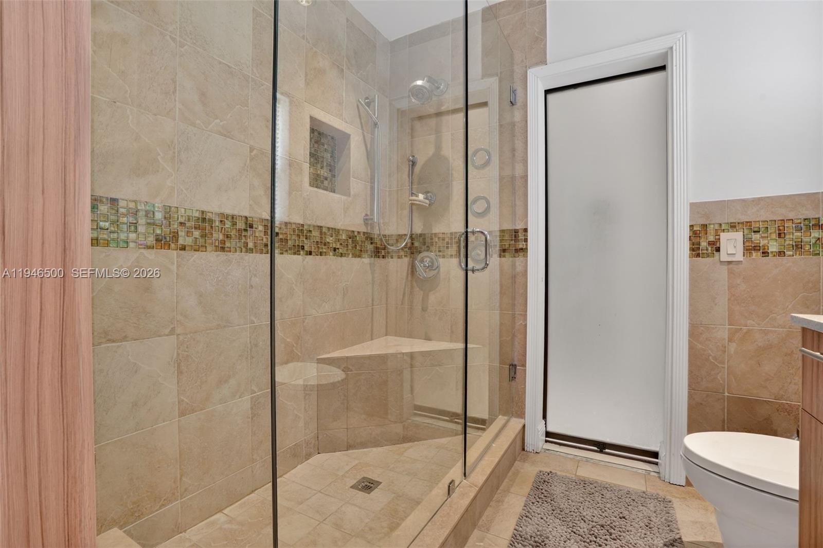4710 Grant Street Hollywood, FL 33021 - Photo 23 of 56 a bathroom with a shower a toilet and a sink