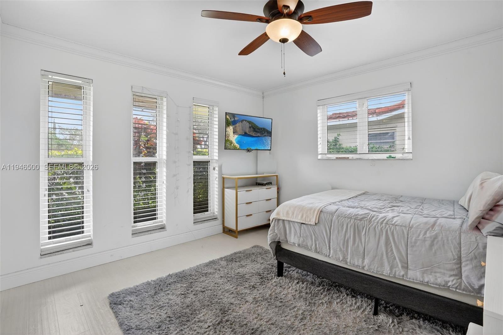 4710 Grant Street Hollywood, FL 33021 - Photo 24 of 56 a bedroom with a bed and a chandelier