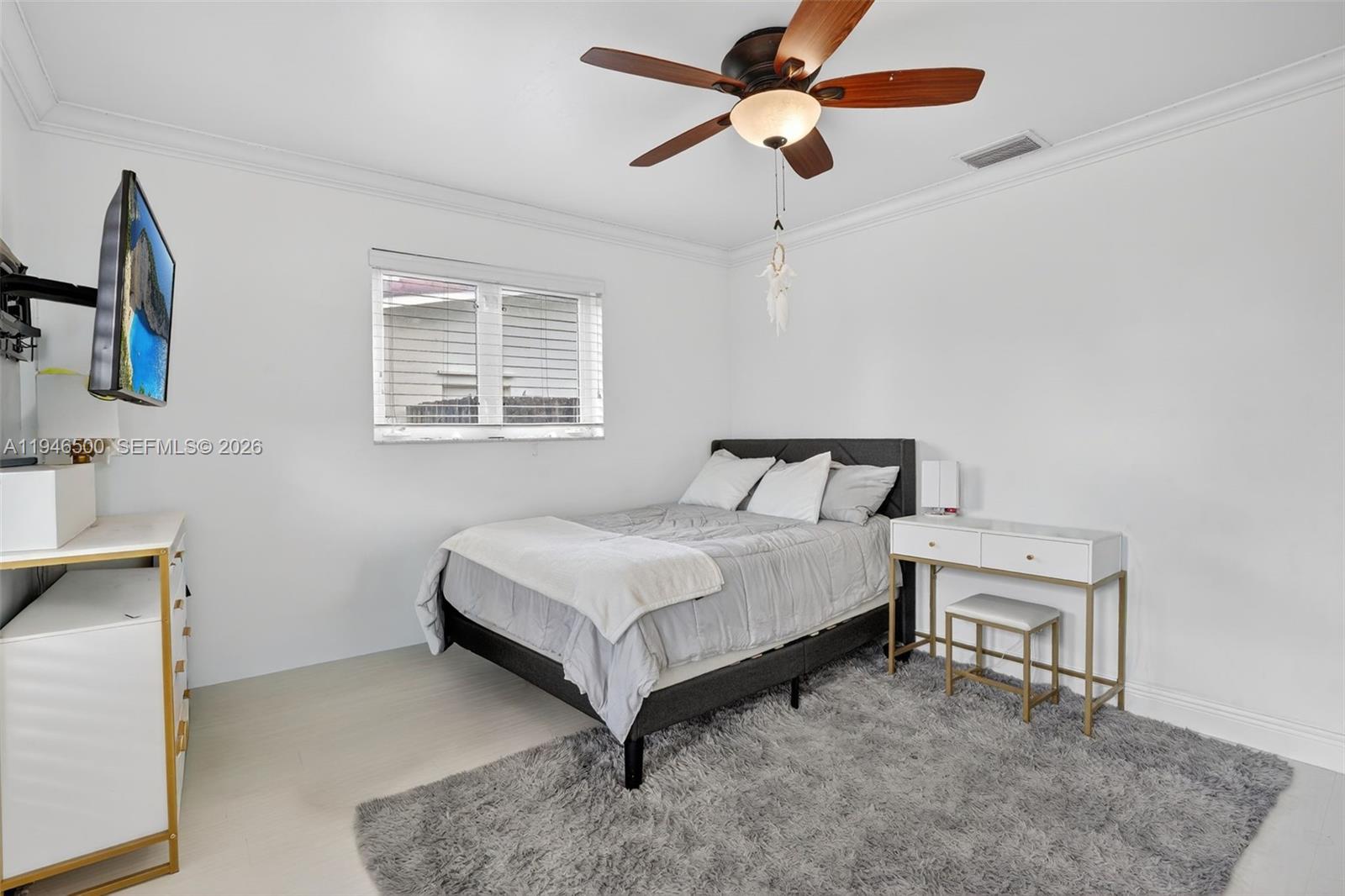 4710 Grant Street Hollywood, FL 33021 - Photo 25 of 56 a bedroom with a bed and a chandelier