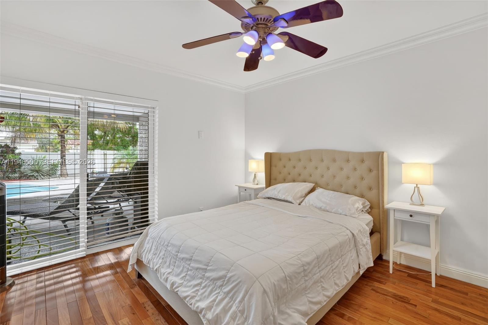 4710 Grant Street Hollywood, FL 33021 - Photo 29 of 56 a bedroom with a large bed and a chandelier