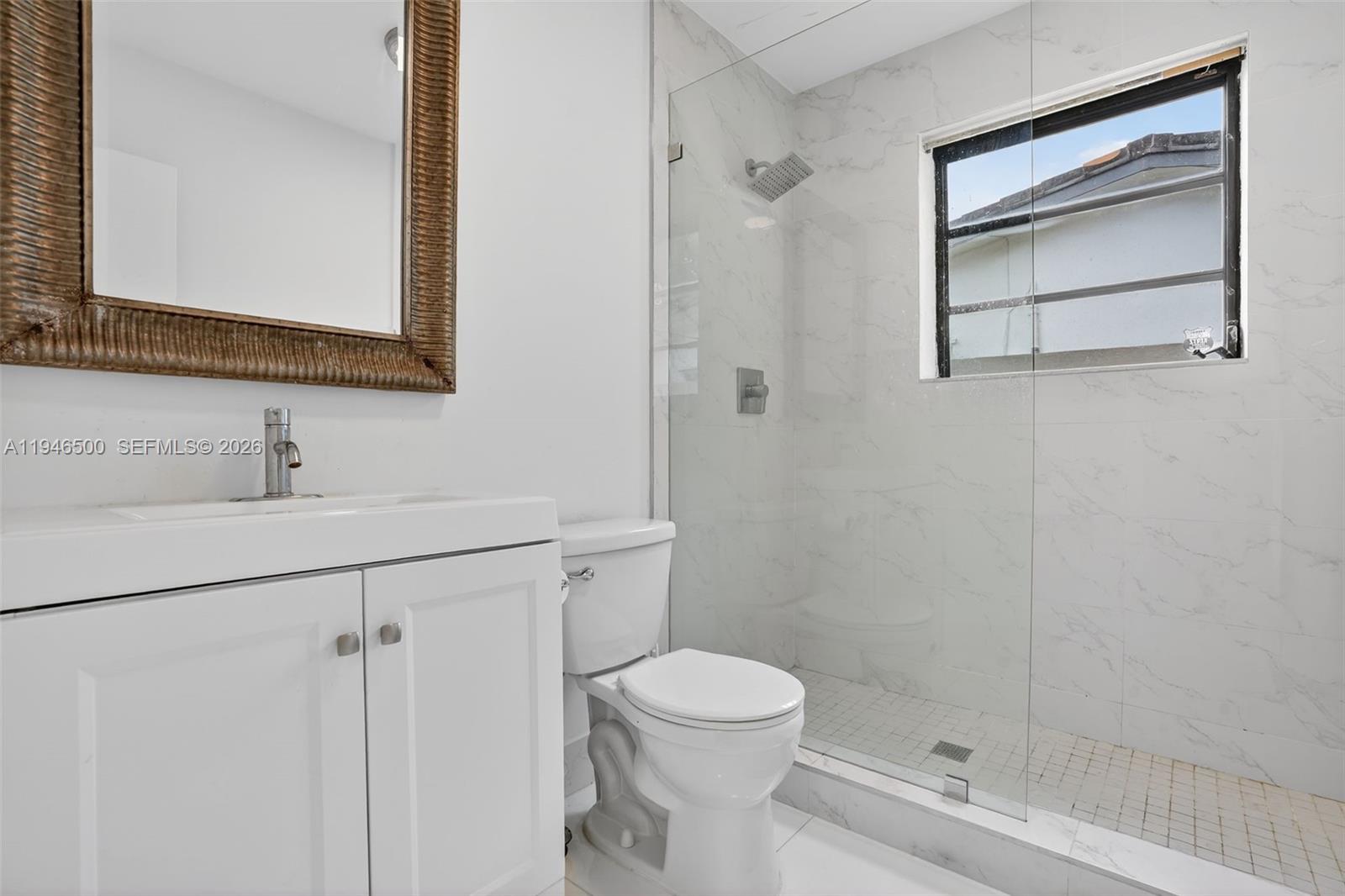 4710 Grant Street Hollywood, FL 33021 - Photo 31 of 56 a bathroom with a toilet sink and shower