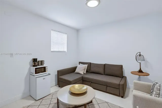 a view of a livingroom with furniture and a window