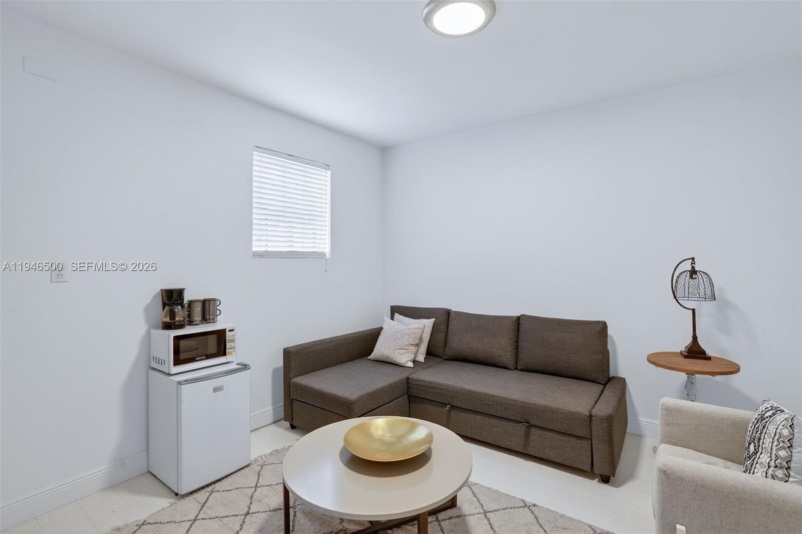 4710 Grant Street Hollywood, FL 33021 - Photo 33 of 56 a living room with furniture and a lamp