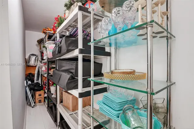 a view of a house with swimming pool and a chairs and tables in patio