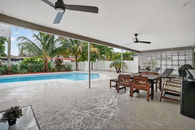 a view of a pathway of house with potted plants