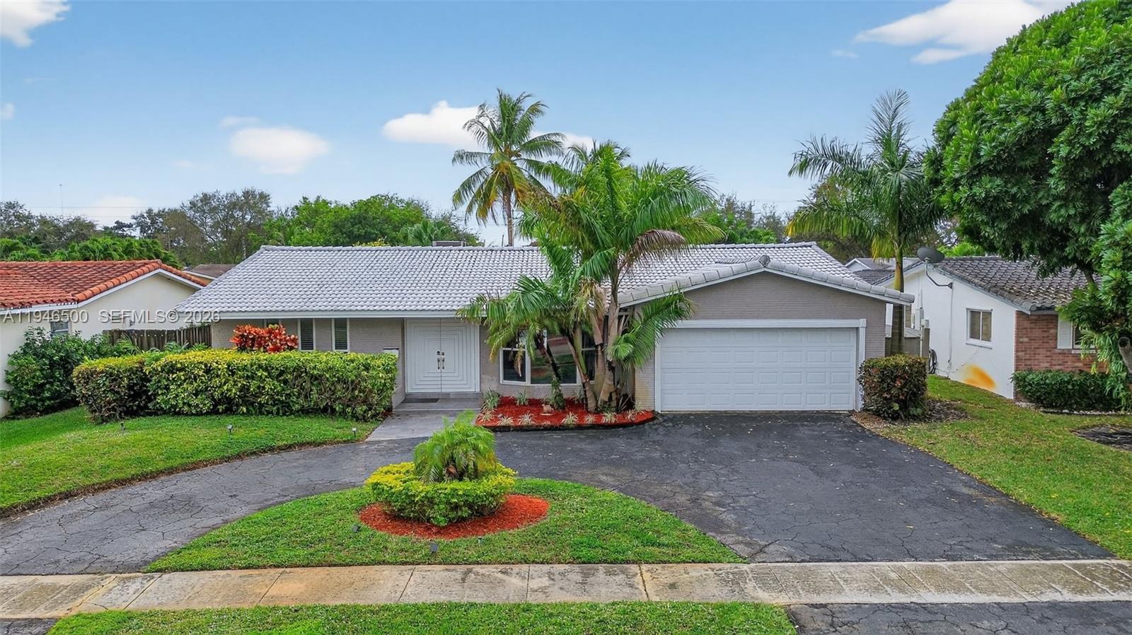 4710 Grant Street Hollywood, FL 33021 - Photo 48 of 56 a front view of a house with a garden and plants