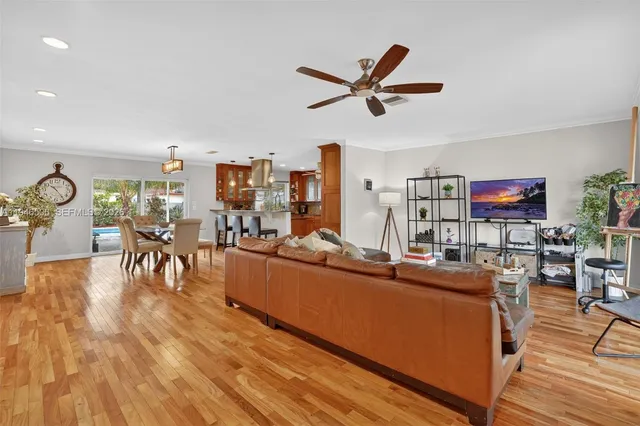 a living room with furniture a rug and a flat screen tv