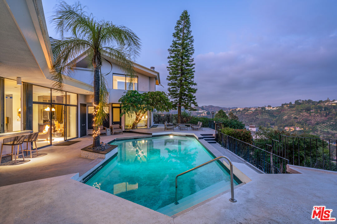 960 Stradella Road Los Angeles, CA 90077 - Photo 12 of 17 a swimming pool with outdoor seating yard and mountain view