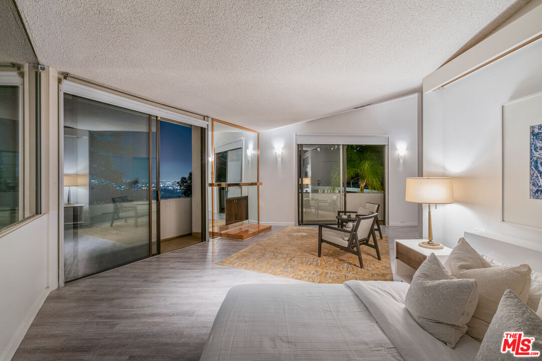 960 Stradella Road Los Angeles, CA 90077 - Photo 15 of 17 a living room with furniture and a lamp