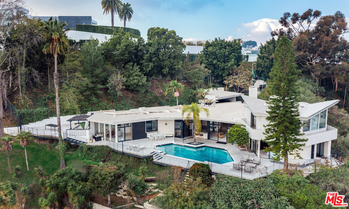 960 Stradella Road Los Angeles, CA 90077 - Photo 2 of 17 a view of a house with a yard and potted plants
