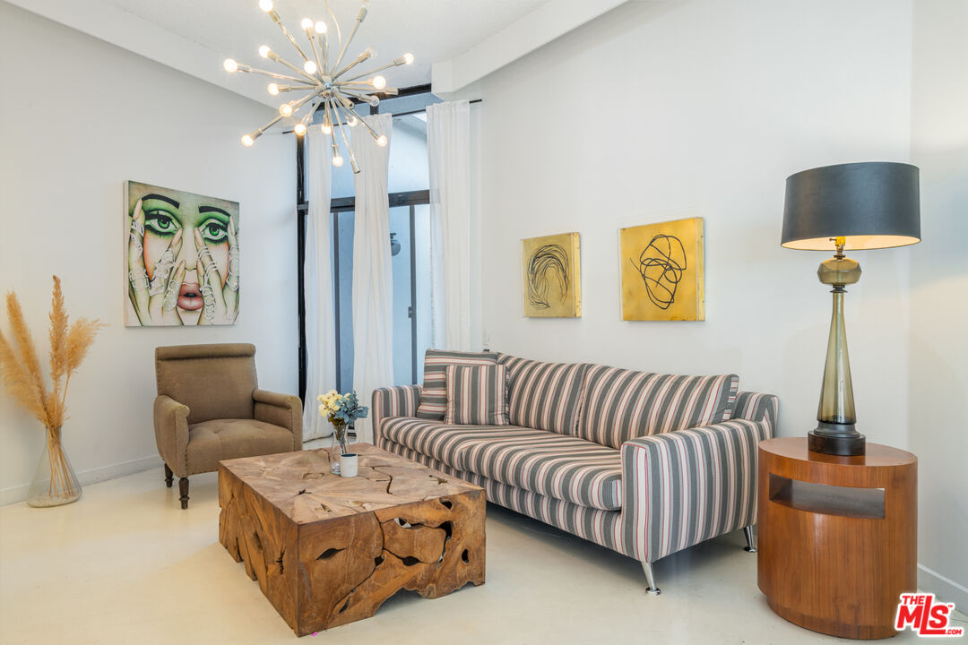 960 Stradella Road Los Angeles, CA 90077 - Photo 4 of 17 a living room with furniture and a lamp