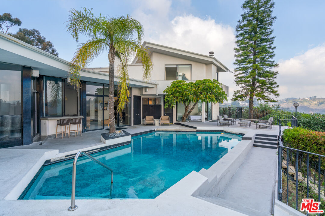 960 Stradella Road Los Angeles, CA 90077 - Photo 7 of 17 a view of a house with swimming pool and sitting area