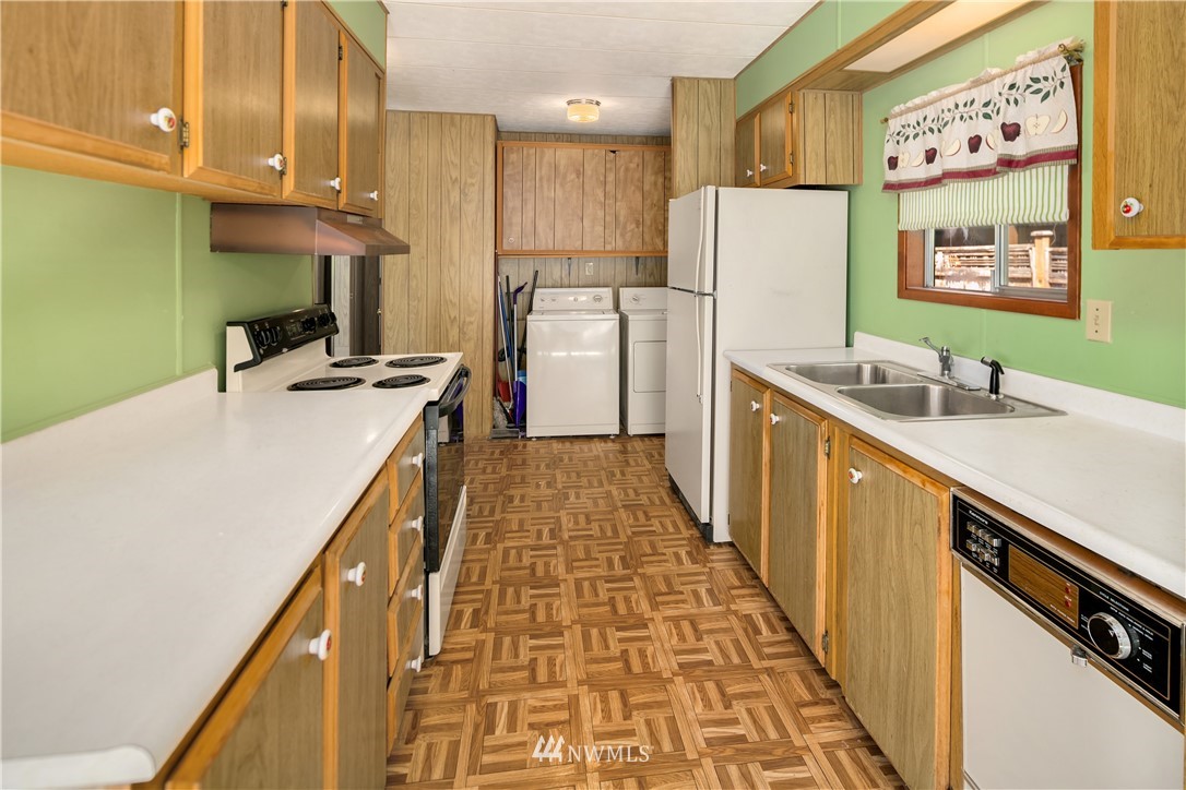 18902 128th Place Northeast Bothell, WA 98011 - Photo 5 of 15 a kitchen with a sink a refrigerator and a stove