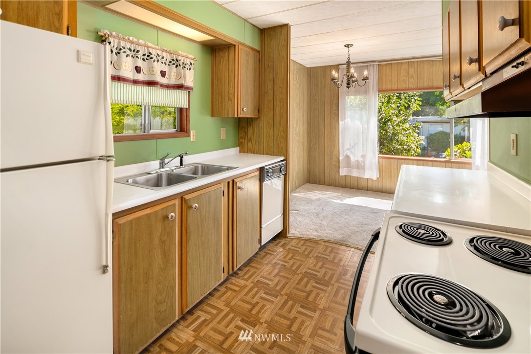 18902 128th Place Northeast Bothell, WA 98011 - Photo 6 of 15 a kitchen with a refrigerator and a stove