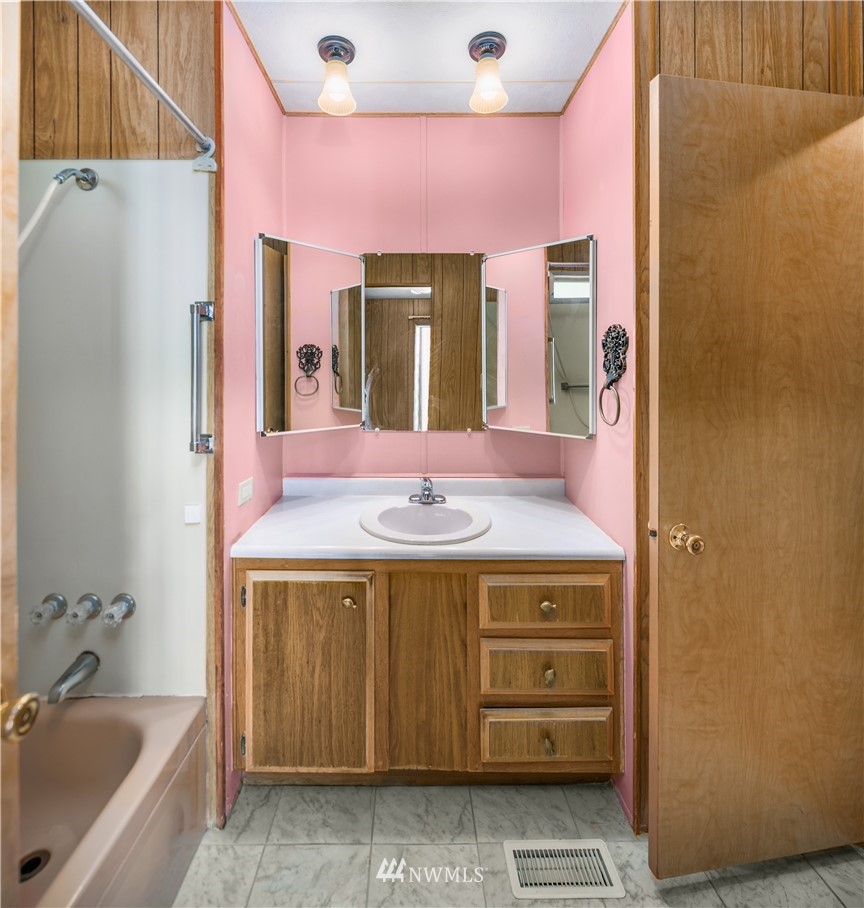 18902 128th Place Northeast Bothell, WA 98011 - Photo 10 of 15 a bathroom with a sink a vanity and a large mirror