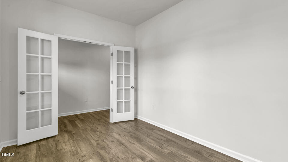 1305 Pavo Path Wendell, NC 27591 - Photo 7 of 55 a view of an empty room with wooden floor and closet