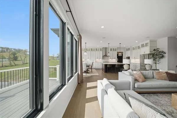 a kitchen that has a lot of cabinets in it wooden floors and appliances