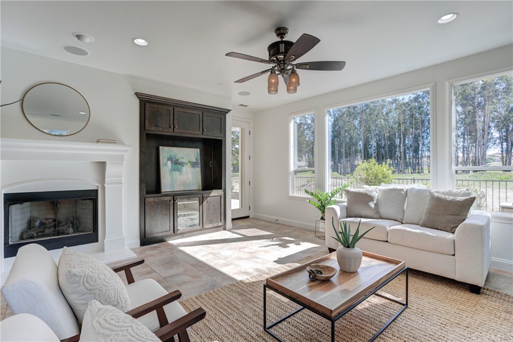 1715 Trilogy Parkway Nipomo, CA 93444 - Photo 17 of 69 a living room with furniture a fireplace and a floor to ceiling window