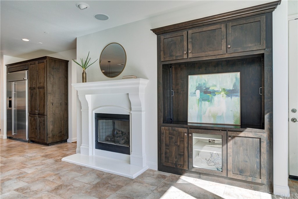 1715 Trilogy Parkway Nipomo, CA 93444 - Photo 19 of 69 a living room with a fireplace and a flat screen tv
