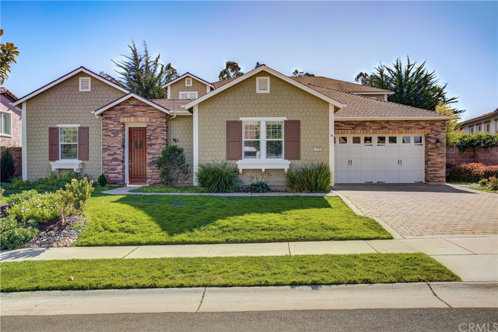 1715 Trilogy Parkway Nipomo, CA 93444 - Photo 3 of 69 a front view of a house with a yard and garage
