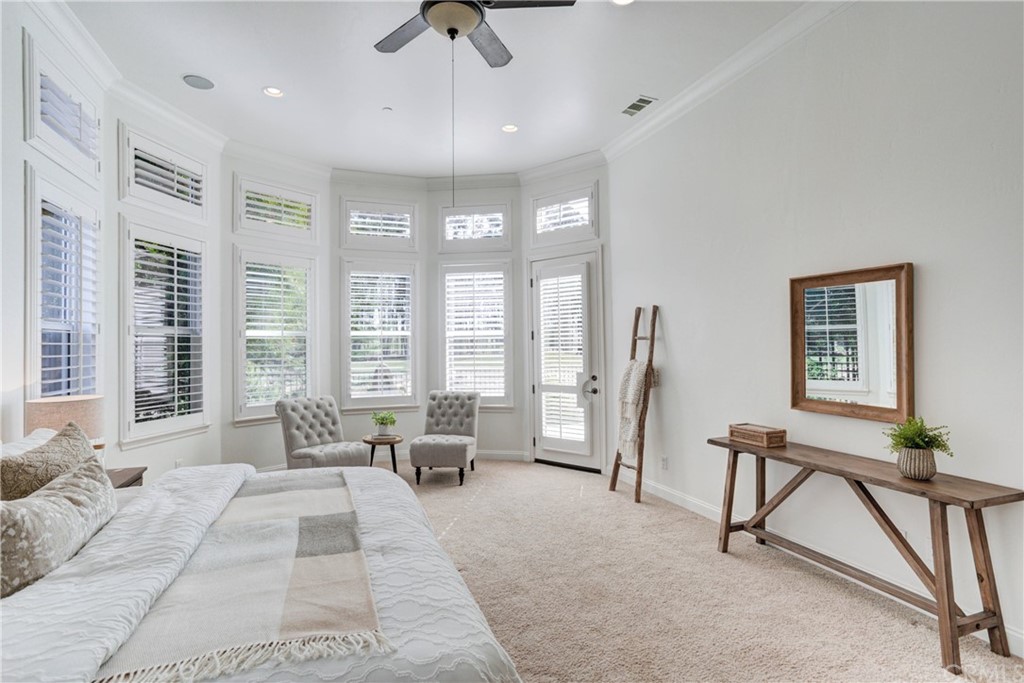 1715 Trilogy Parkway Nipomo, CA 93444 - Photo 46 of 69 a spacious bedroom with a bed a couch and large window