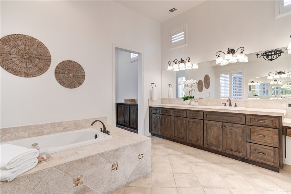 1715 Trilogy Parkway Nipomo, CA 93444 - Photo 51 of 69 a spacious bathroom with a granite countertop sink a mirror and bathtub