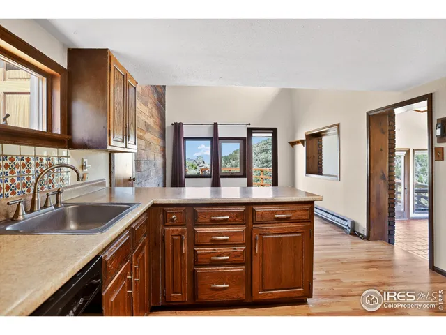 a kitchen with granite countertop a sink and a wooden floor