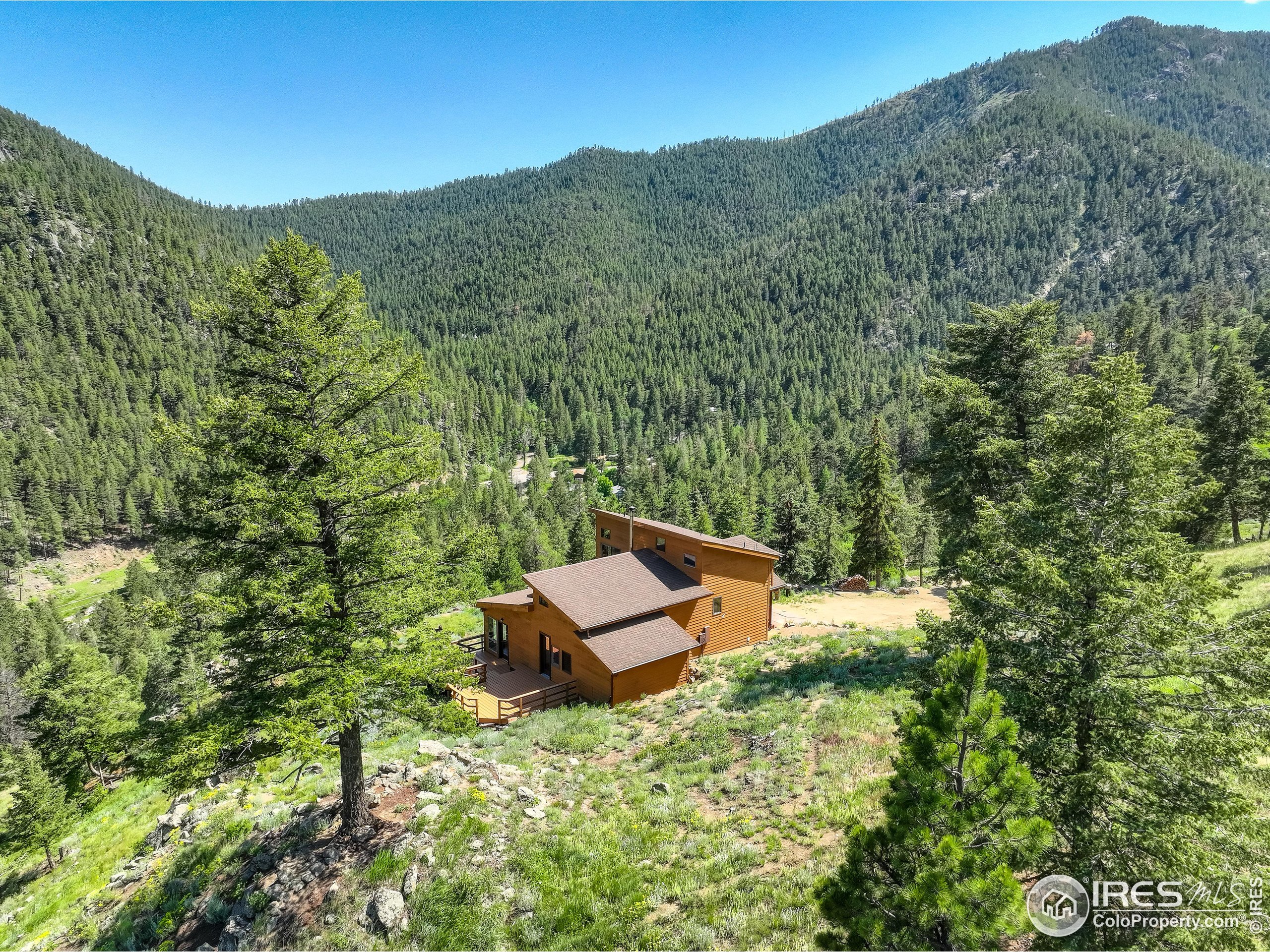 192 Nugget Hill Road Jamestown, CO 80455 - Photo 24 of 25 a view of a mountain with a lush green forest