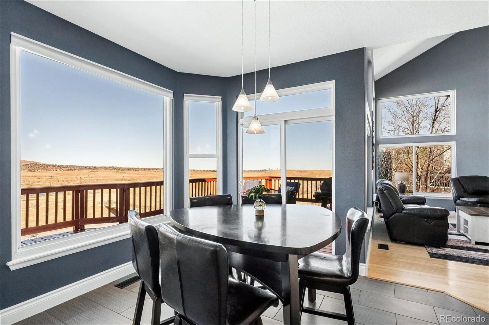 4143 South Deframe Court Morrison, CO 80465 - Photo 23 of 48 a dining room with furniture window and wooden floor