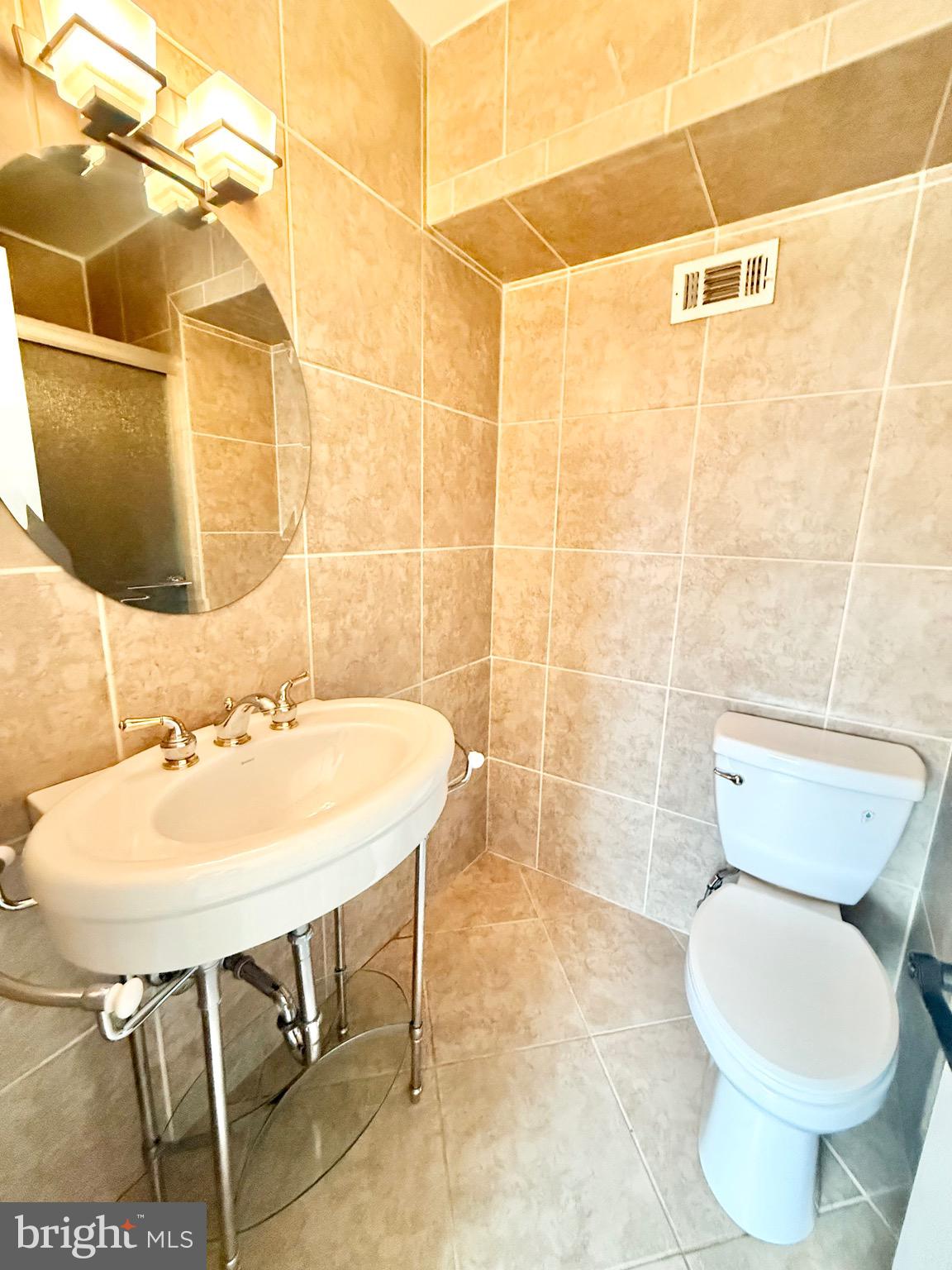 5439 Richenbacher Avenue Alexandria, VA 22304 - Photo 14 of 23 a bathroom with a sink toilet and shower