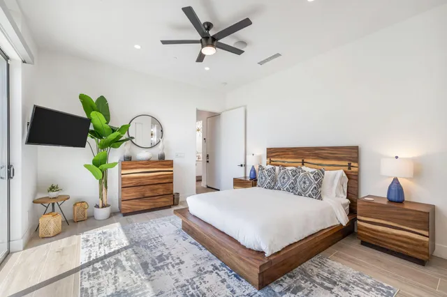 a bedroom with a bed dresser and a window