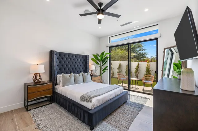 a bedroom with a large bed and a large window